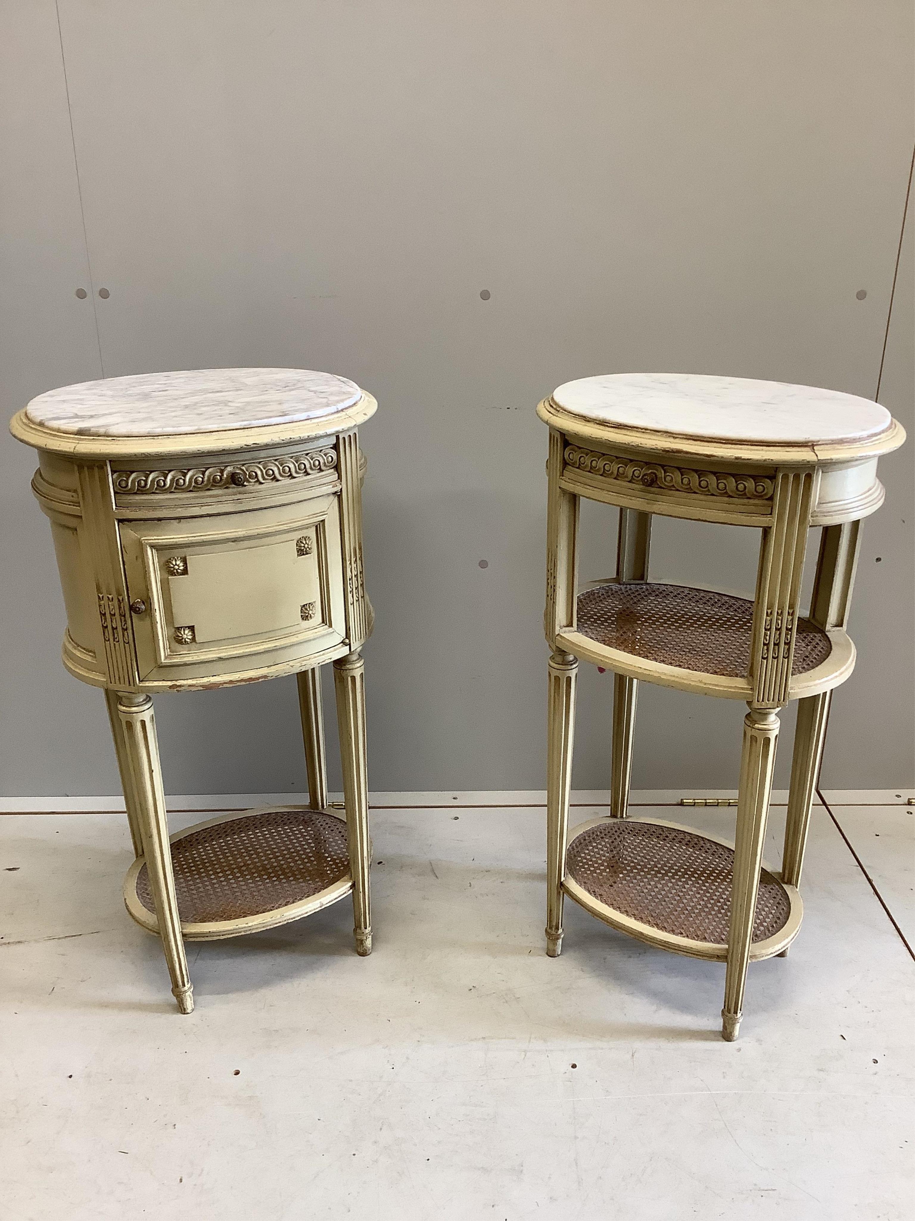 A pair of French cream painted bedside cabinets with oval marble inset tops, one fitted with a pot cupboard, width 44cm, height 83cm. Condition - fair, some differing to the marble